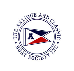 The Antique and Classic Boat Society Inc, white background with name circling in blue letters, red and blue triangle inside circle with white triangle blue letter a inside white triangle. Red white and blue triangles in the shape of a flag